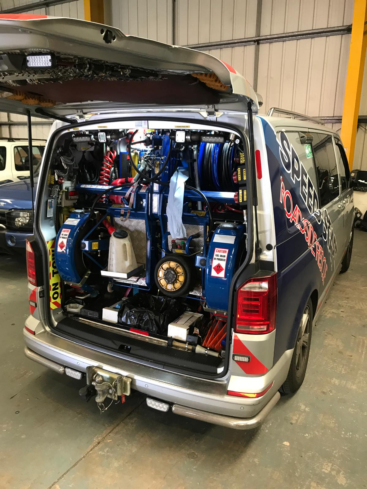 Van boot open from a different angle showing tools and equipment